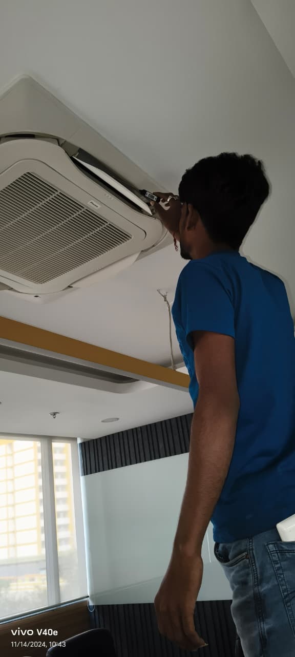 Ceiling cassette air conditioner being serviced