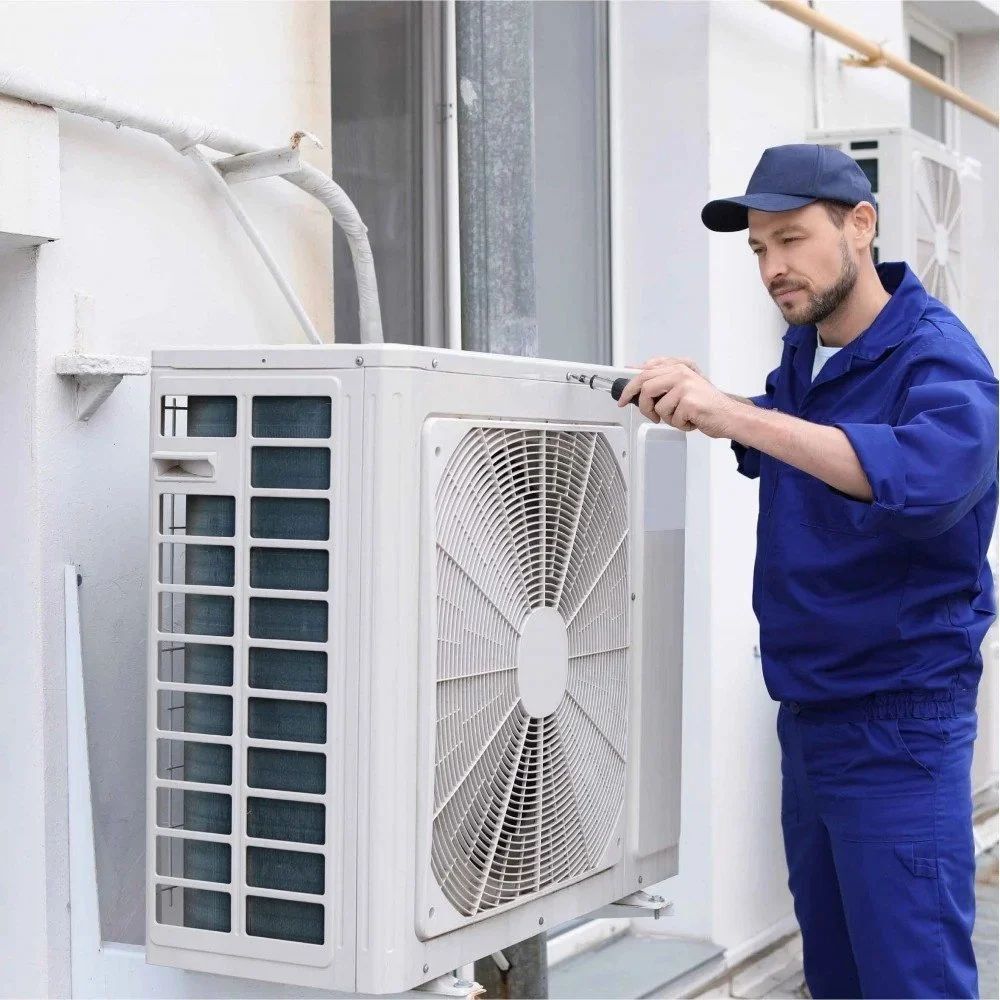 Technician inspecting residential outdoor AC equipment